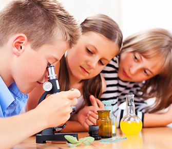 students looking through a microscope