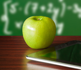 an apple sitting on a desk with a tablet