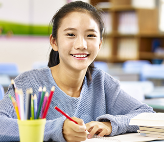 girl doing her school work at her desk