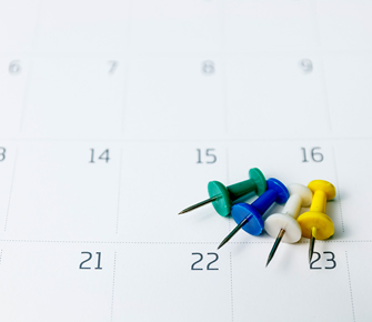 a calendar with push pins