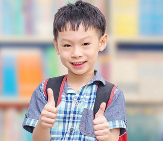 little boy giving a thumbs up