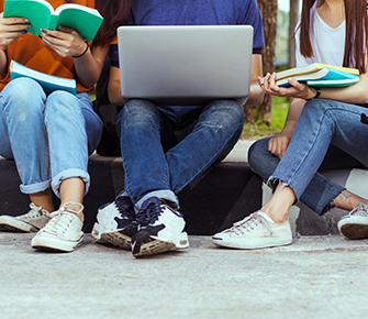 students with laptop and books