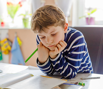 male student working at his desk