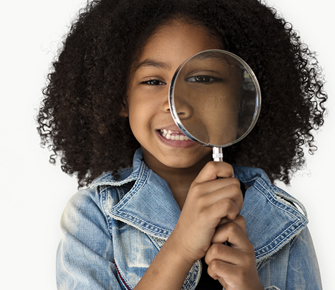 little girl holding a magnify glass to her eye