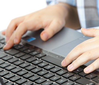 hands typing on a laptop