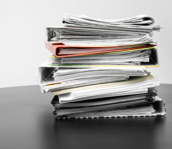 Stack of binders and documents