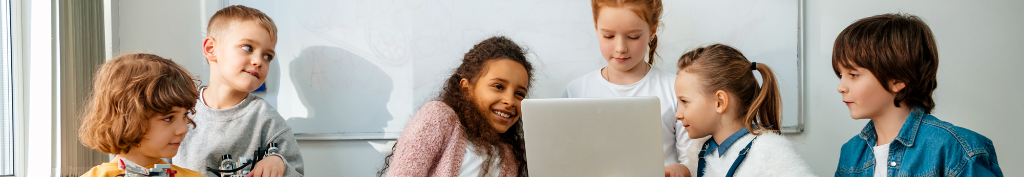 six students looking at a computer